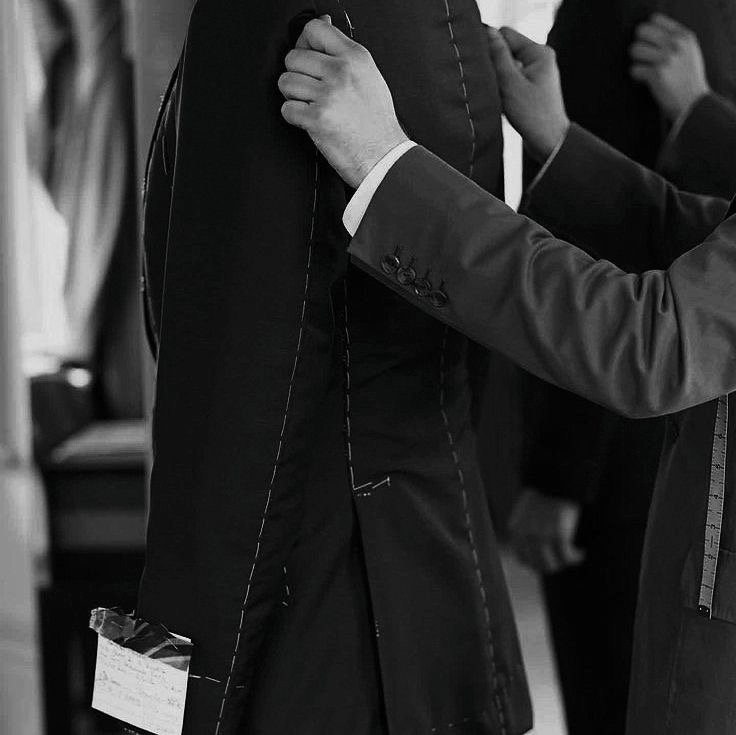 Butler assisting with a tailored suit for private household service