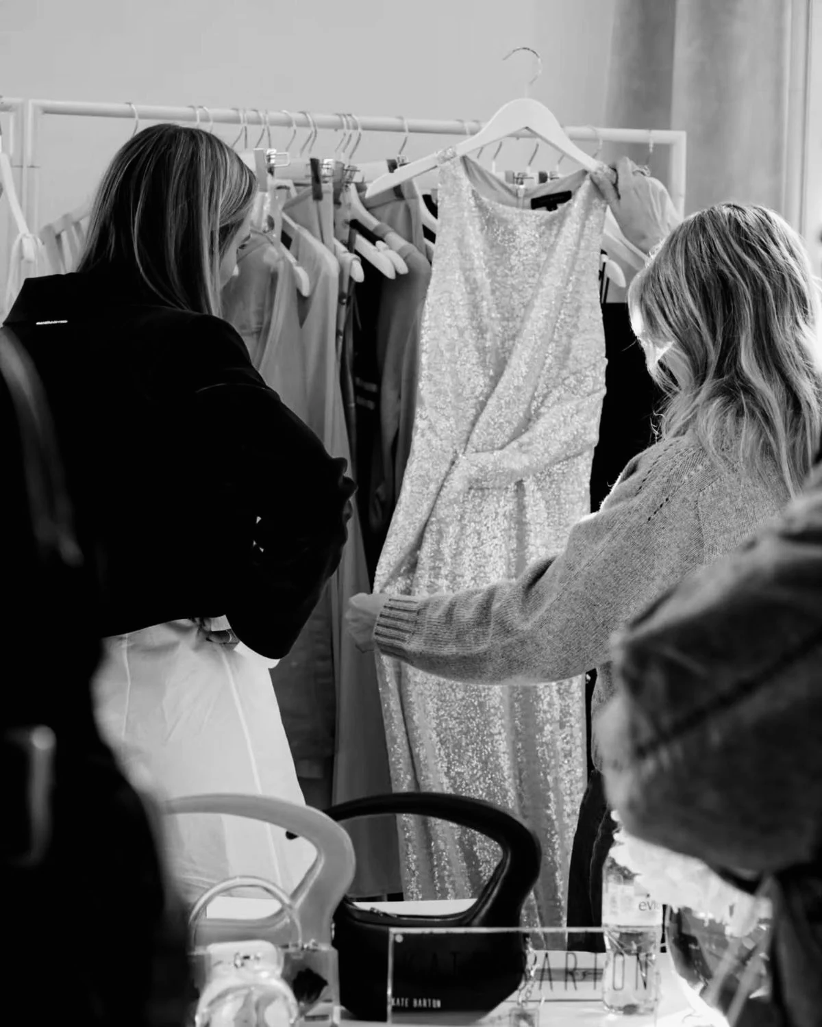 A stylist and client reviewing a dress during a private wardrobe consultation