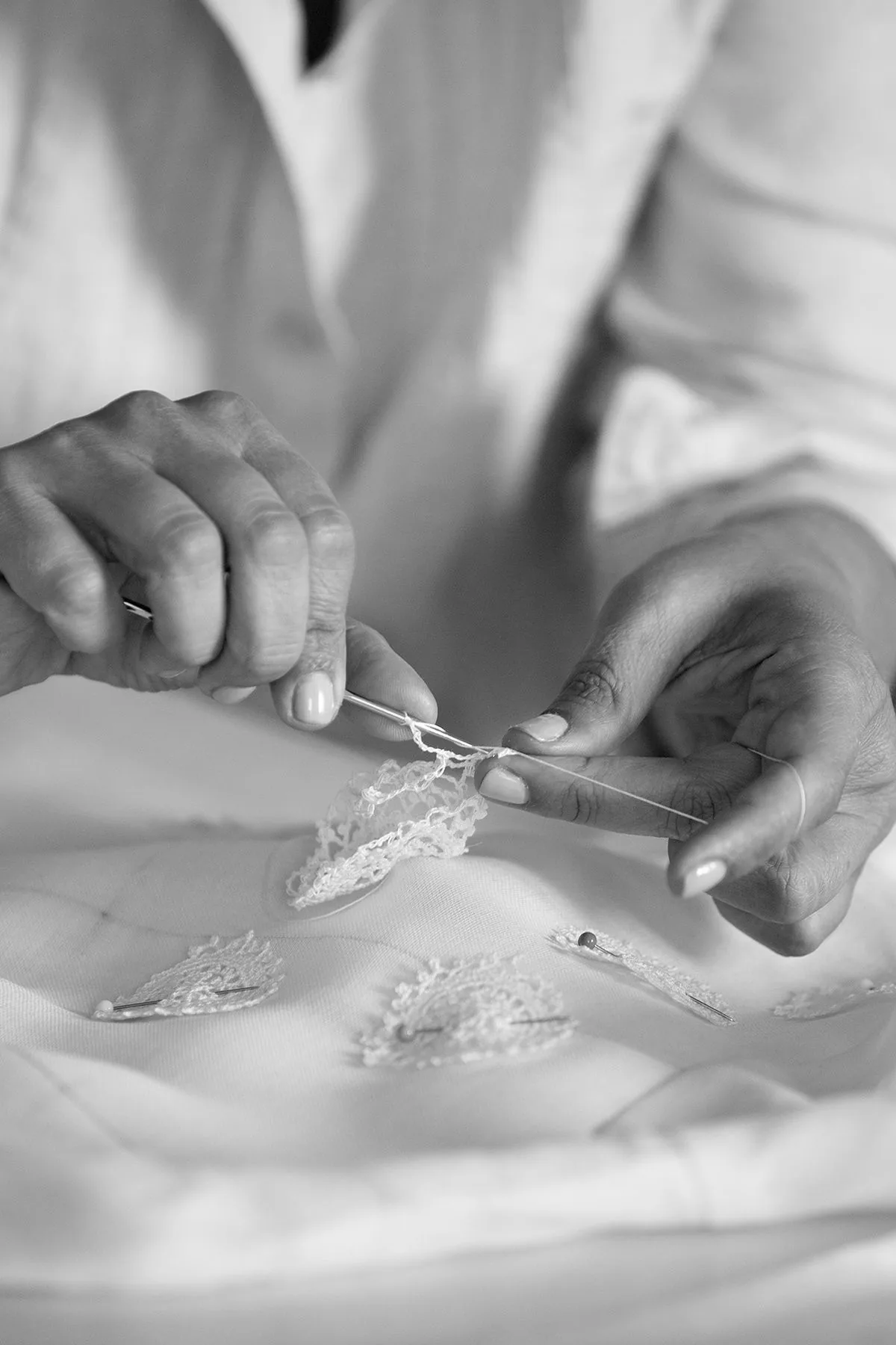 Close-up of an artisan handcrafting delicate lace on fabric